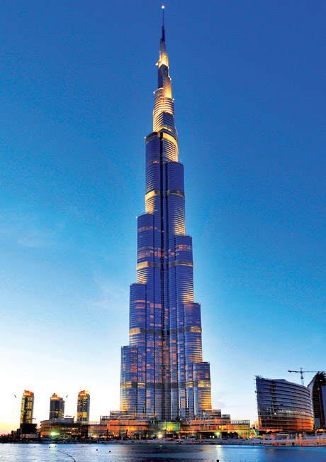 The Burj Dubai, the world's tallest skyscraper, developed by Emaar Properties PJSC, is illuminated at night as it towers over the Business Bay area in Dubai, United Arab Emirates, on Tuesday, Nov. 24, 2009. Dubai, whose government and state-owned companies borrowed $80 billion to fund an economic boom, raised $5 billion by selling bonds after the credit crisis battered its property and finance industries. Photographer: Charles Crowell/Bloomberg